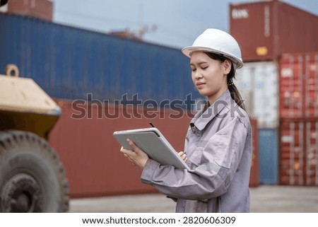 Professional logistics worker inspecting cargo containers at warehouse yard. Shipping, freight transport