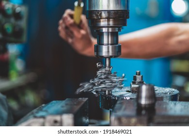 Professional machinist hand working with milling machine in metalworking factory, lathe metalworking industry concept