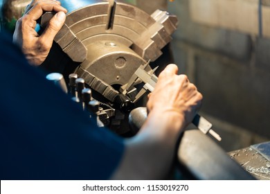 Professional machinist : man operating lathe grinding machine - metalworking industry concept.
Mechanical Engineering control lathe machine in factory.