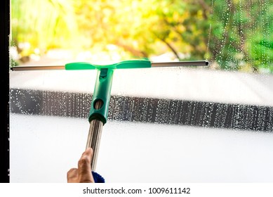 Professional Maid Cleaning Window In Office