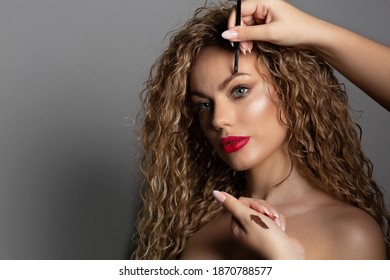 Professional Makeup Artist Applying Brow Pomade To A Woman's Eyebrows. Copyspace