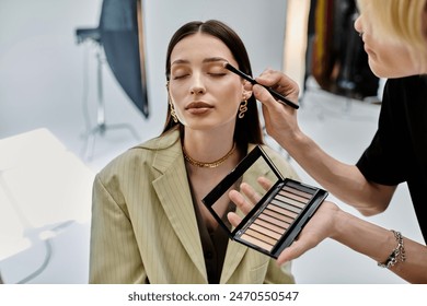 Professional makeup artist applying makeup to a woman.