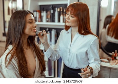 Professional Makeup Artist Doing Makeup For Female Client In Beauty Salon. Beauty Services