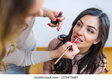 Professional makeup artist working with beautiful young woman.  Woman applying by professional make up master. Beauty club concept - Shutterstock ID 1376975687