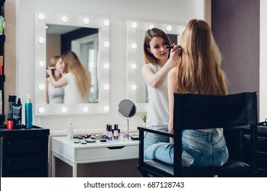 Professional Makeup Artist Working On Young Girl Creating Natural Look In Beauty Salon