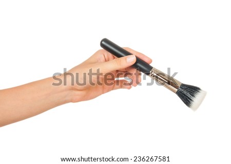 Professional make-up brush cosmetic in female hand beautician isolated on white background