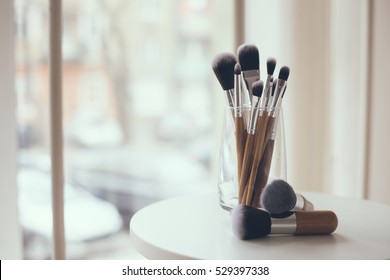 Professional makeup brushes in a glass