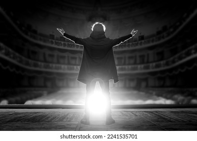 Professional male actor on the stage of the theater against the backdrop of an empty hall. Black and white photo - Shutterstock ID 2241535701