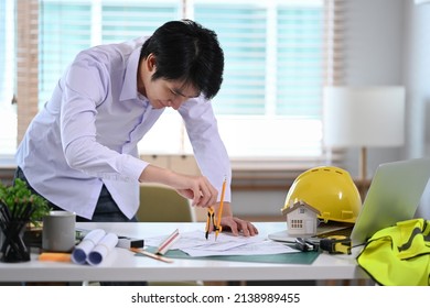 Professional Male Architect Drawing Plan On Blueprint With Architect Equipment.