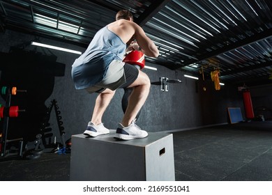 Professional male athlete doing plyometric training indoors - Powered by Shutterstock