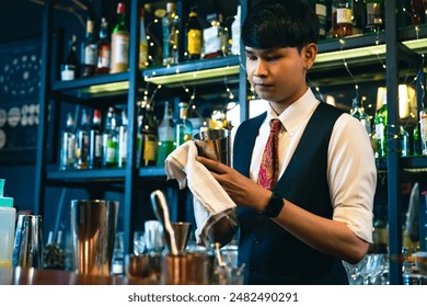 Professional male bartender preparing and serving cocktail drink to customer on bar counter at luxury nightclub. Barman making mixed alcoholic drink for celebrating holiday party at restaurant bar. - Powered by Shutterstock