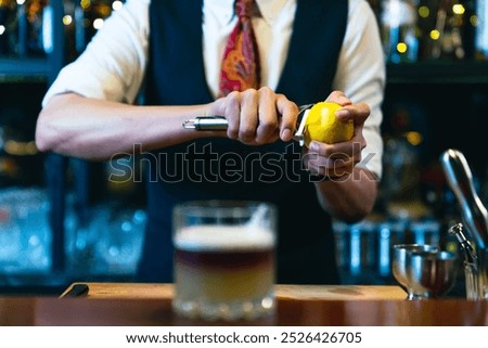 Professional male bartender preparing and serving cocktail drink to customer on bar counter at luxury nightclub. Barman making mixed alcoholic drink for celebrating holiday party at restaurant bar.