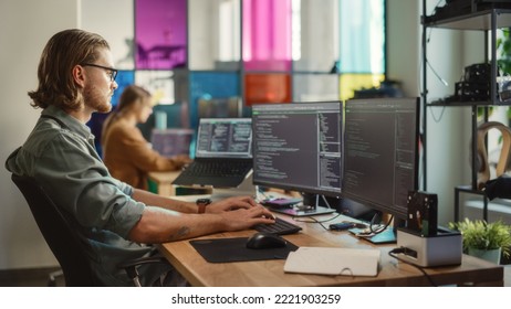 Professional Male Developer Writing Code On Desktop Computer With Two Displays And A Laptop In Creative Office. Caucasian Man Programming Artificial Intelligence Software For Big Tech Company.