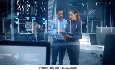 Professional Male and Female Engineers Working in High Tech Research Lab with Data Servers using Computers and Tablets showing Data and Graphs. - Powered by Shutterstock