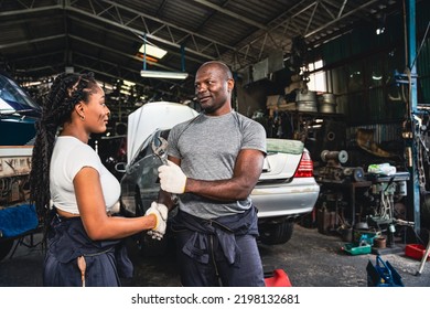 Professional Male And Female Mechanic Checking Hands In The Other Hand He Holds A Wrench In The Garage.