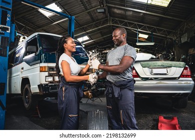 Professional Male And Female Mechanic Checking Hands In The Other Hand He Holds A Wrench In The Garage.