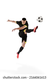 Professional male football soccer player in motion and action isolated on white studio background. Concept of sport, goals, competition, hobby, ad, world cup. Sportsmen wearing black football kit
