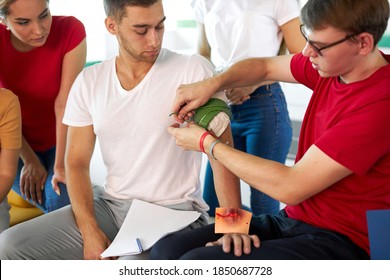 Professional Male Instructor Use Tourniquet To Prevent Bleeding During First Aid Training, Teach People To Save The Life