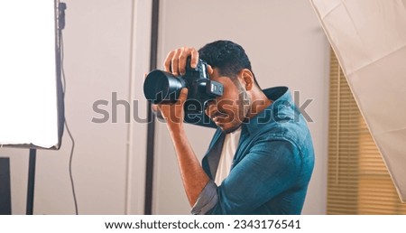Professional male photographer working in studio.