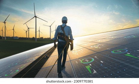 Professional Male Sustainable Energy Engineer Walking On Industrial Solar Panel, Wearing Safety Equipment. Man Inspecting Green Energy Farm With Wind Turbines. VFX Infographics Edit Shows Data. - Powered by Shutterstock