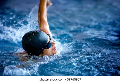 Professional Male Swimmer In A Pool With Hat And Goggles