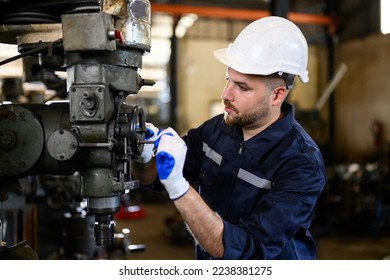 Professional male technician checking and repairing machinery at manufacturing factory - Powered by Shutterstock