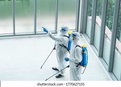 Professional  male worker In protective clothing and masks are spraying disinfectants, cleaning, controlling virus and bacteria in the contaminated area After the spread of coronavirus or COVID-19 - Powered by Shutterstock