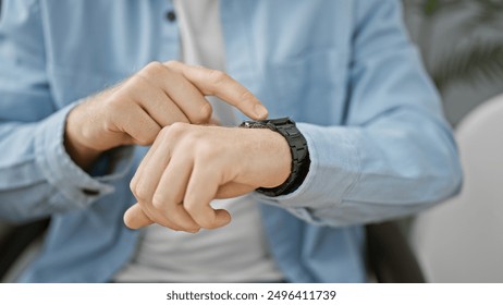 A professional man checks the time on his wristwatch in an office setting, conveying punctuality and responsibility. - Powered by Shutterstock