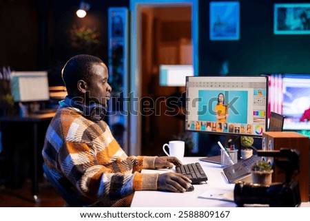 Professional man in creative setup at home using digital tools for graphic design and photo retouching, illustrating the modern tech driven design industry. Advanced tech industry.
