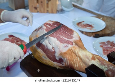 Professional Man Hands Chef Slicing Iberico Spanish Ham In Restaurant Event Party Table