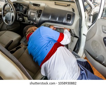 A Professional Man Is Replacing Or Changing The Ac Air Filter Of A Modern Vehicle And Wearing Blue And White Uniform And Laying Down In The Car 