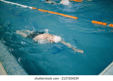 Professional Man Swimmer Inside Indoor Swimming Pool