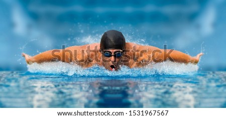 Professional man in swimming pool. Butterfly swimming style