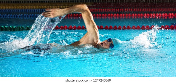 Professional man in swimming pool. Crawl swimming style