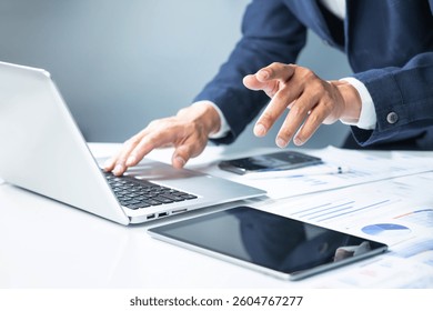 Professional man using computer laptop at modern workspace.Entrepreneur working proactive.Data analysis and strategy planning for success.Not ai generated