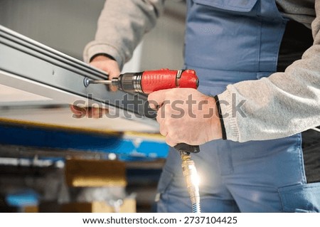 Professional man worker engaged in assembly of PVC doors and windows