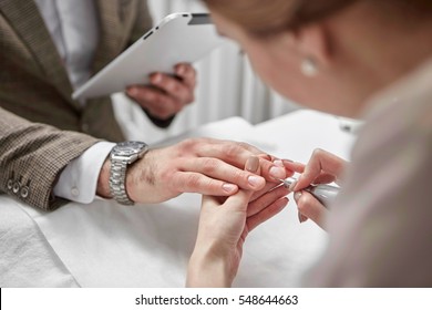 professional manicure for man by manicure machine - Shutterstock ID 548644663