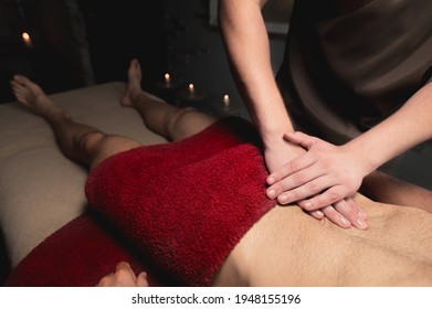 Professional Massage Of The Abdomen For A Man To An Athlete In A Dark Spa Room. Removal Of Adhesions Healthy Intestines