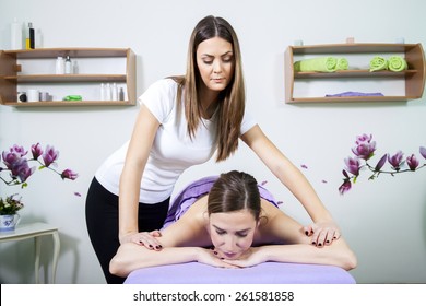 Professional Massage Therapist Massaging A Young Woman