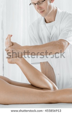 Similar – Hands massaging female abdomen.