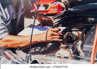 Professional Mechanic Checks The Airflow Operation Of The Air Filter System, The Diesel Pickup Truck And Notes The Electrical System Defects Together During The Maintenance : Selective Focus