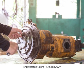 Professional Mechanic Engineer Loosing Bolt Of Gear Hydraulic Piston Pump, Repair Maintenance Heavy Machinery Concept