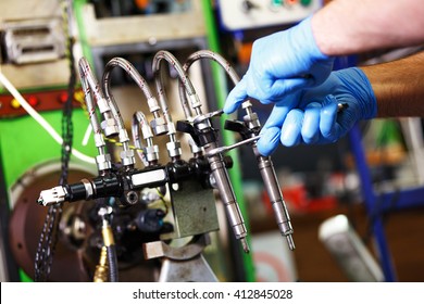 Professional Mechanic Testing Diesel Injector In His Workshop.