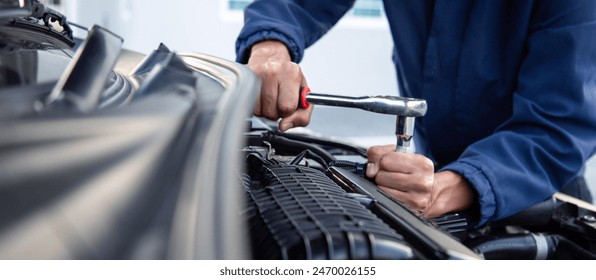 Professional mechanic working on the engine , repairing a car engine automotive workshop with a wrench, car service and maintenance,Repair service. - Powered by Shutterstock