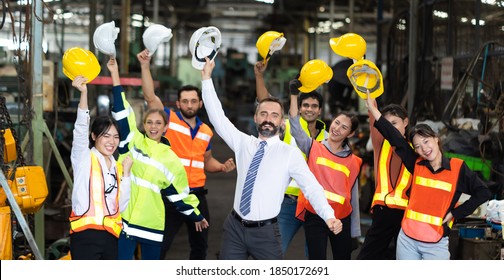 Professional Mechanical Engineer Team At Metal Lathe Industrial Manufacturing Factory. Success Happy Worker Throw Hard Hat Helmet To Celebrate At Workplace.