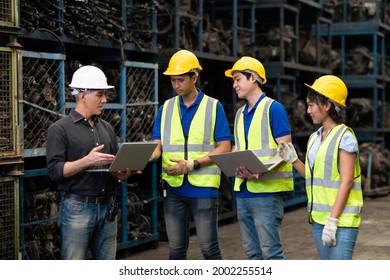 Professional Mechanical Engineer Team Working On Personal Computer At Second-hand Spare Parts Of Old Car Parts Warehouse Store. 