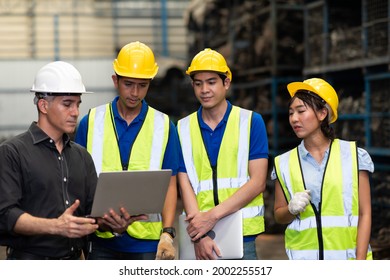 Professional Mechanical Engineer Team Working On Personal Computer At Second-hand Spare Parts Of Old Car Parts Warehouse Store. 