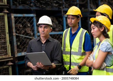 Professional Mechanical Engineer Team Working On Personal Computer At Second-hand Spare Parts Of Old Car Parts Warehouse Store. 