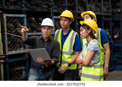 Professional Mechanical Engineer Team Working On Personal Computer At Second-hand Spare Parts Of Old Car Parts Warehouse Store. 