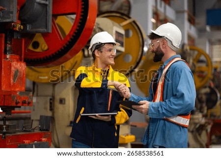 Professional Mechanical Engineer team Working on Personal Computer at Metal lathe industrial manufacturing factory. Engineer Operating lathe Machinery. Product quality Inspection
